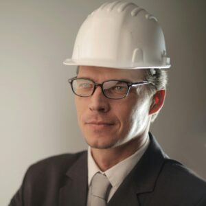 Confident engineer in suit and hard hat, ready for construction project.